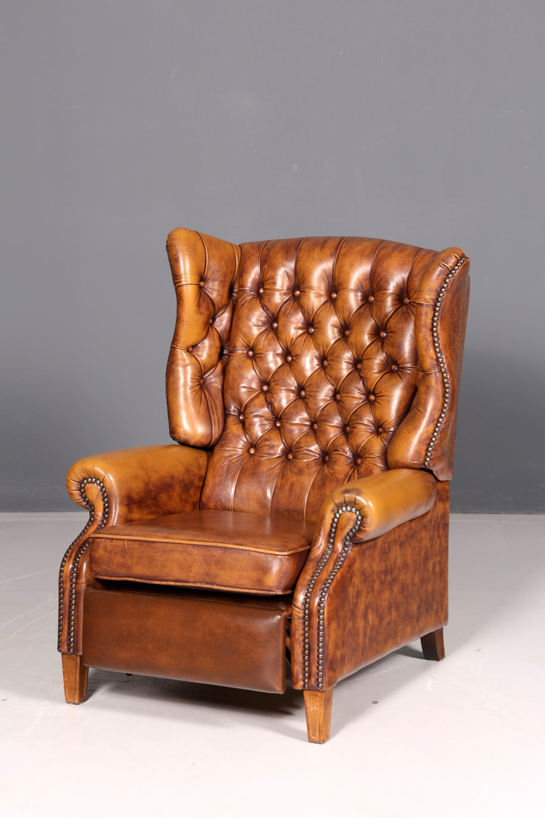 Beautiful original Chesterfield wingback armchair, English genuine leather gentleman’s chair, recliner with reclining function, vintage