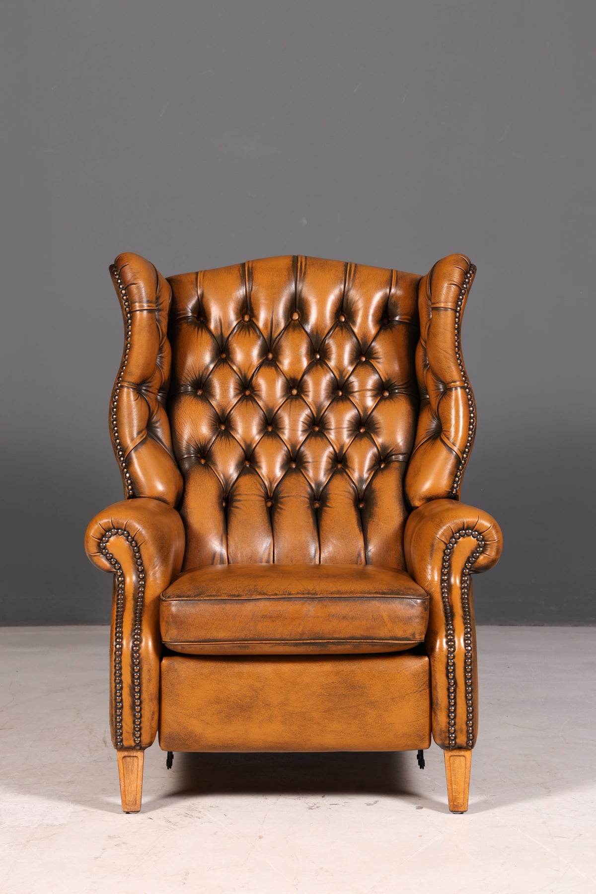 Beautiful original Chesterfield wingback armchair, English genuine leather gentleman’s chair, recliner with reclining function, vintage