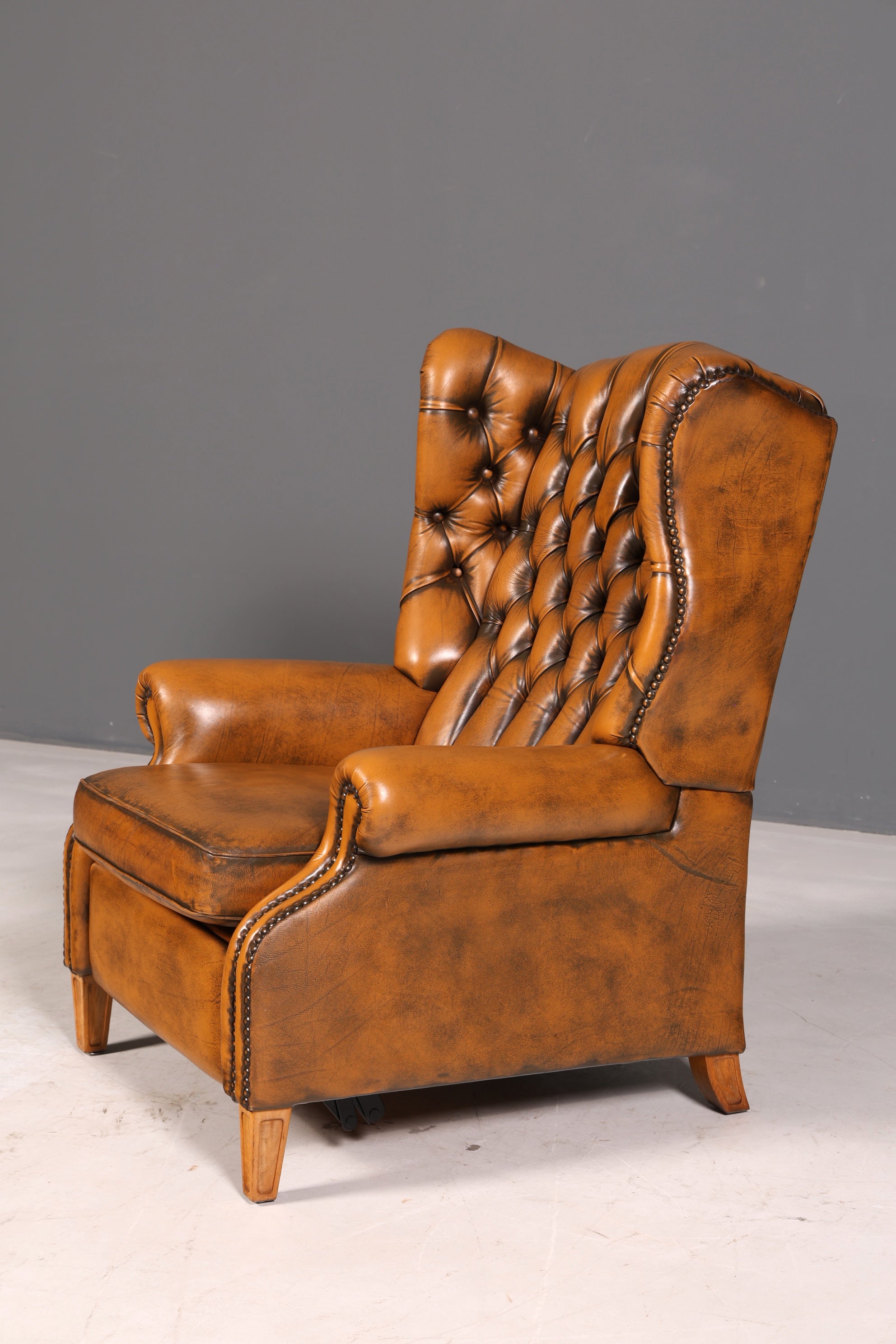 Beautiful original Chesterfield wingback armchair, English genuine leather gentleman’s chair, recliner with reclining function, vintage